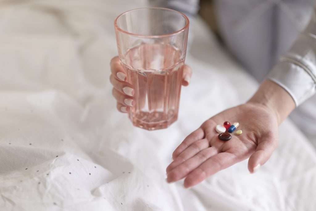 Close Up Hands Holding Pills Water Glass