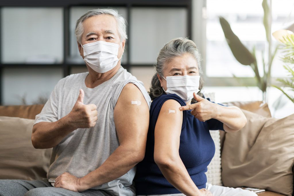 Old Asian Senior Couple Wearing Face Mask Virus Protection Happiness Cheerful Show Bandage Injection Covid19 Vaccinated With Hand Gesture Point Confident Virus Protection